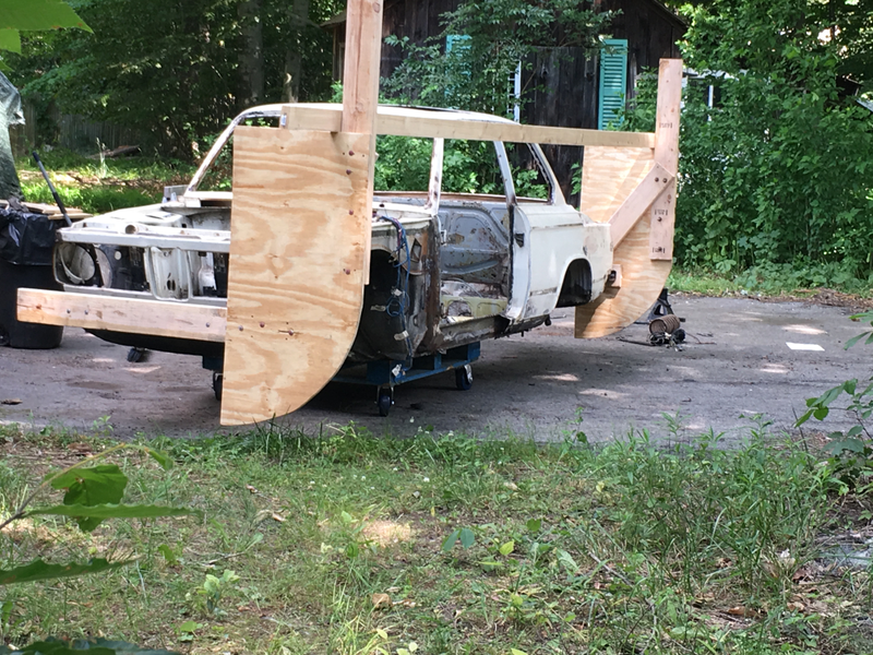 The homebuilt wooden rig used to strip down absolutely everything in the original car.